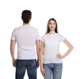 Photo of Woman and man wearing blank t-shirts on white background. Mockup for design