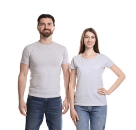 Woman and man wearing blank t-shirts on white background. Mockup for design