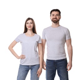 Photo of Woman and man wearing blank t-shirts on white background. Mockup for design