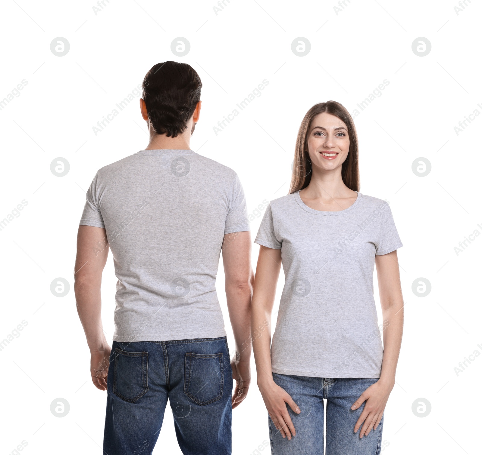 Photo of Woman and man wearing blank t-shirts on white background. Mockup for design