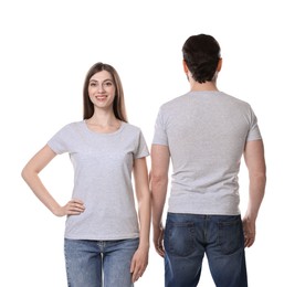 Photo of Woman and man wearing blank t-shirts on white background. Mockup for design