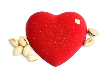 Heart shaped chocolate and pistachios isolated on white, top view