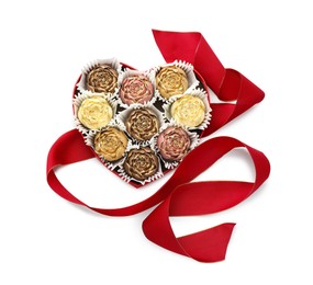 Flower shaped chocolate bonbons in box and red ribbon isolated on white, top view