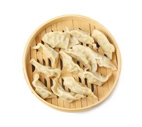 Photo of Tasty boiled gyoza (dumplings) in bamboo steamer on white background, top view