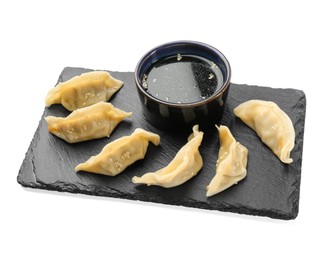 Photo of Tasty boiled gyoza (dumplings) with soy sauce on white background