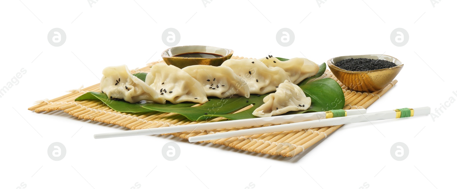 Photo of Tasty boiled gyoza (dumplings) with soy sauce, chopsticks and sesame on white background