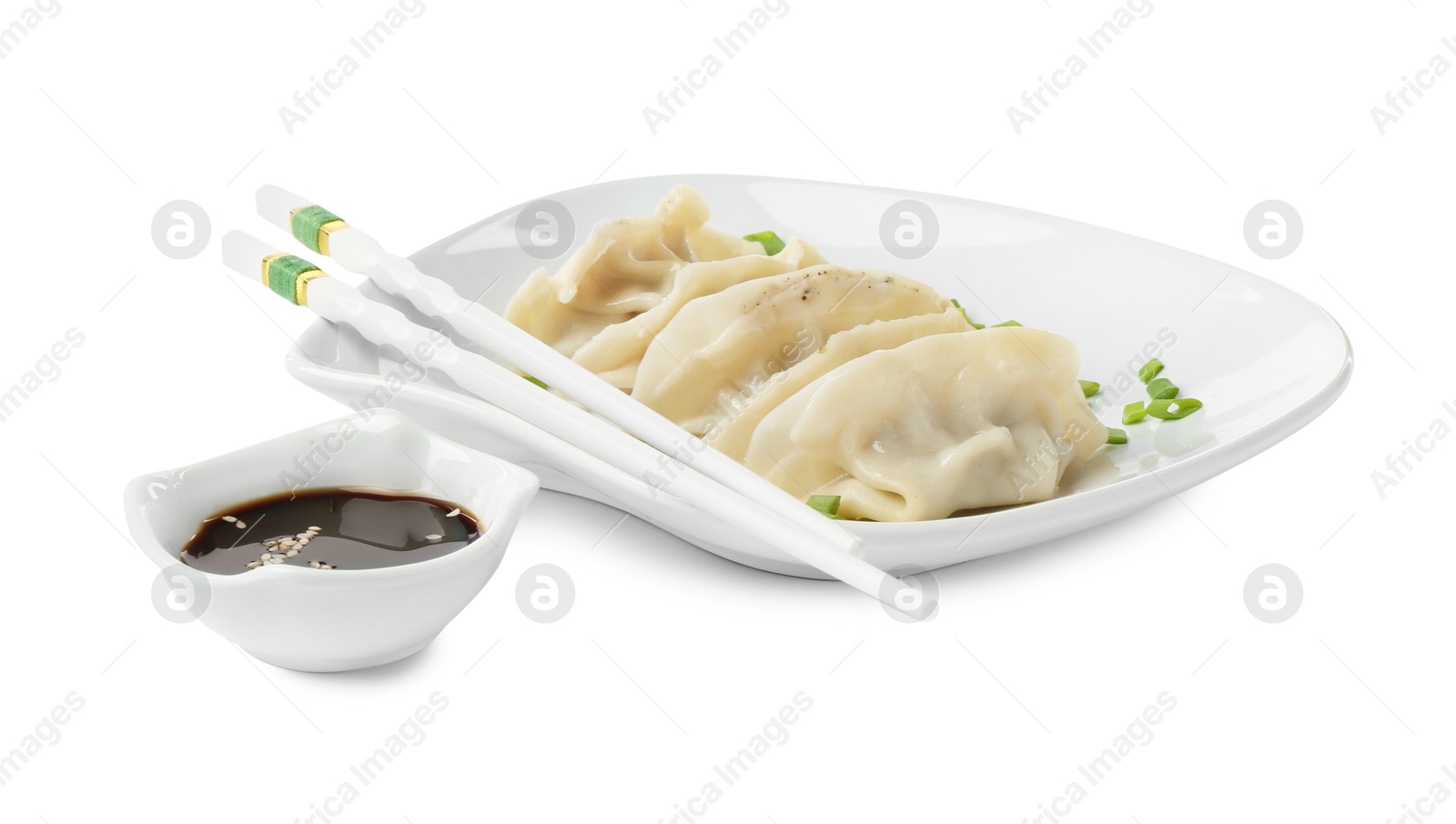 Photo of Tasty boiled gyoza (dumplings) with green onion, soy sauce and chopsticks on white background