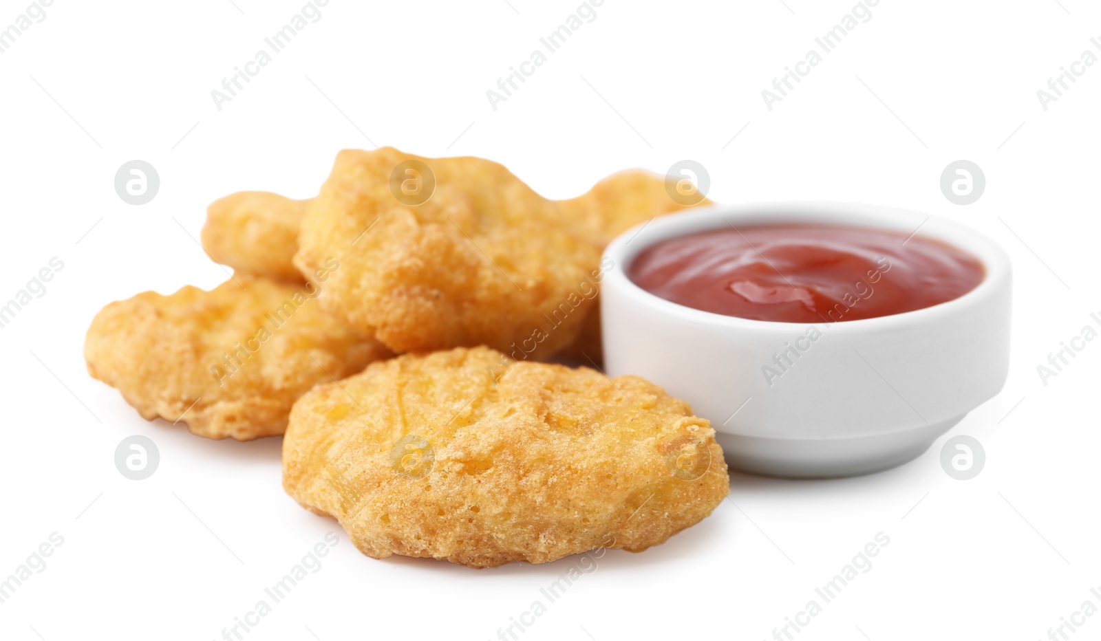 Tasty chicken nuggets with sauce isolated on white Photo of Tasty chicken nuggets with sauce isolated on white