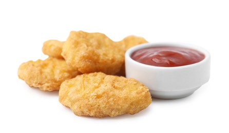 Photo of Tasty chicken nuggets with sauce isolated on white
