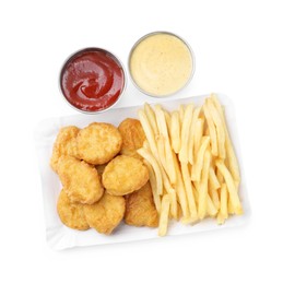 Photo of Tasty chicken nuggets and french fries with sauce isolated on white, top view