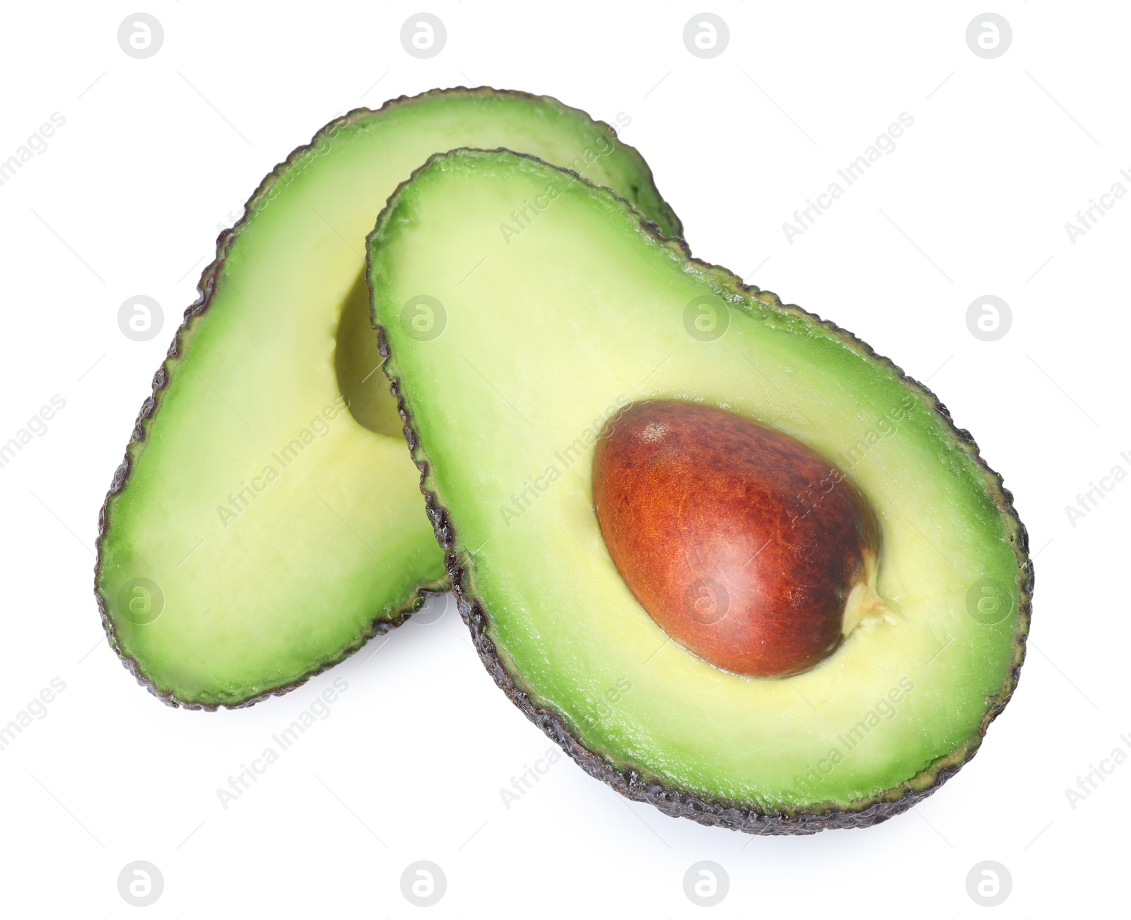 Halves of ripe avocado isolated on white Photo of Halves of ripe avocado isolated on white