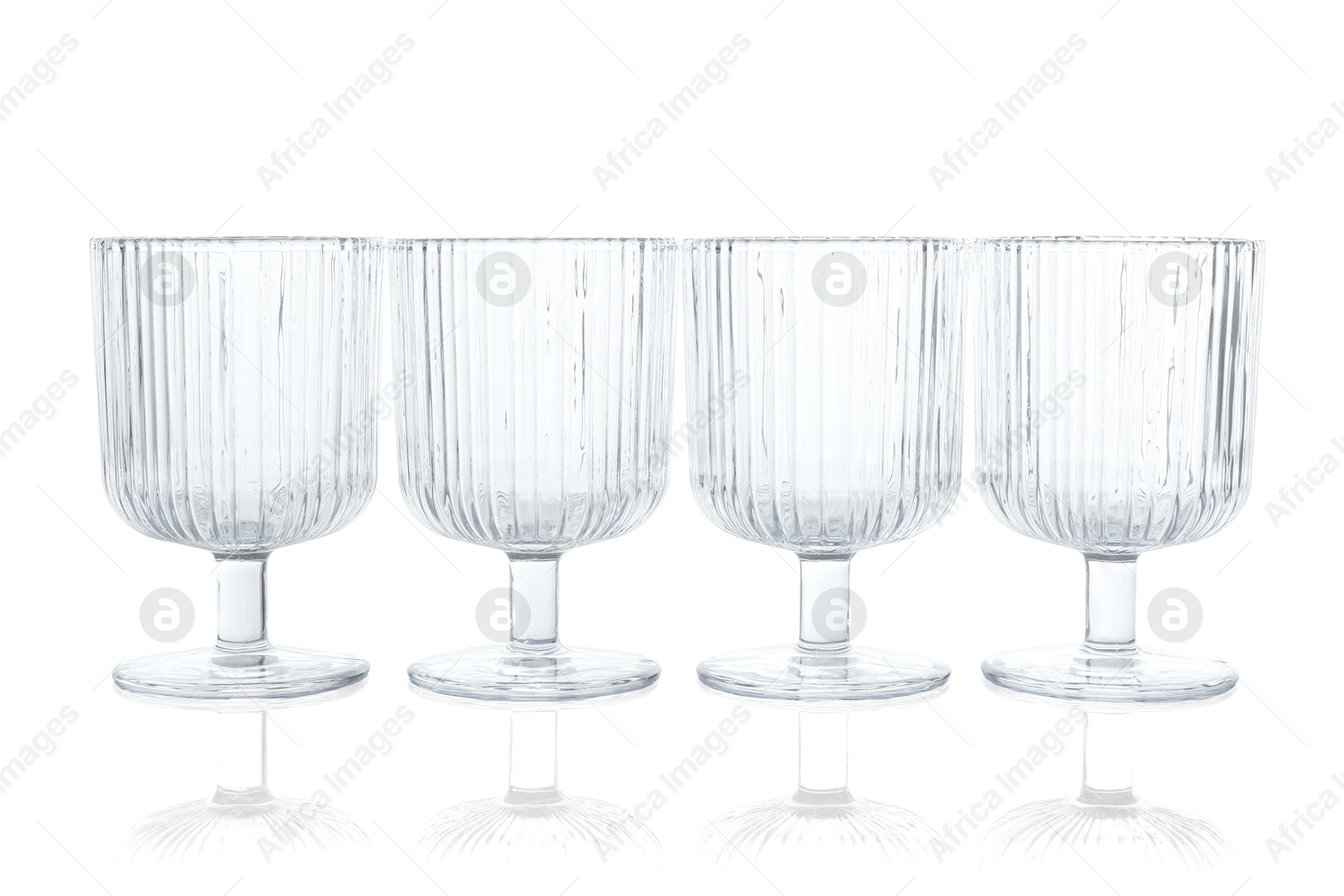 Photo of Many empty clean glasses isolated on white