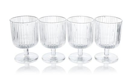 Photo of Many empty clean glasses isolated on white