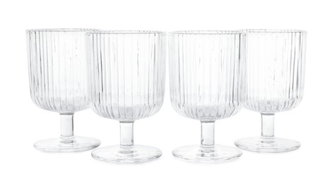 Photo of Many empty clean glasses isolated on white