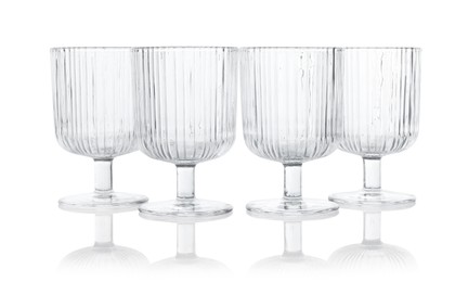 Photo of Many empty clean glasses isolated on white