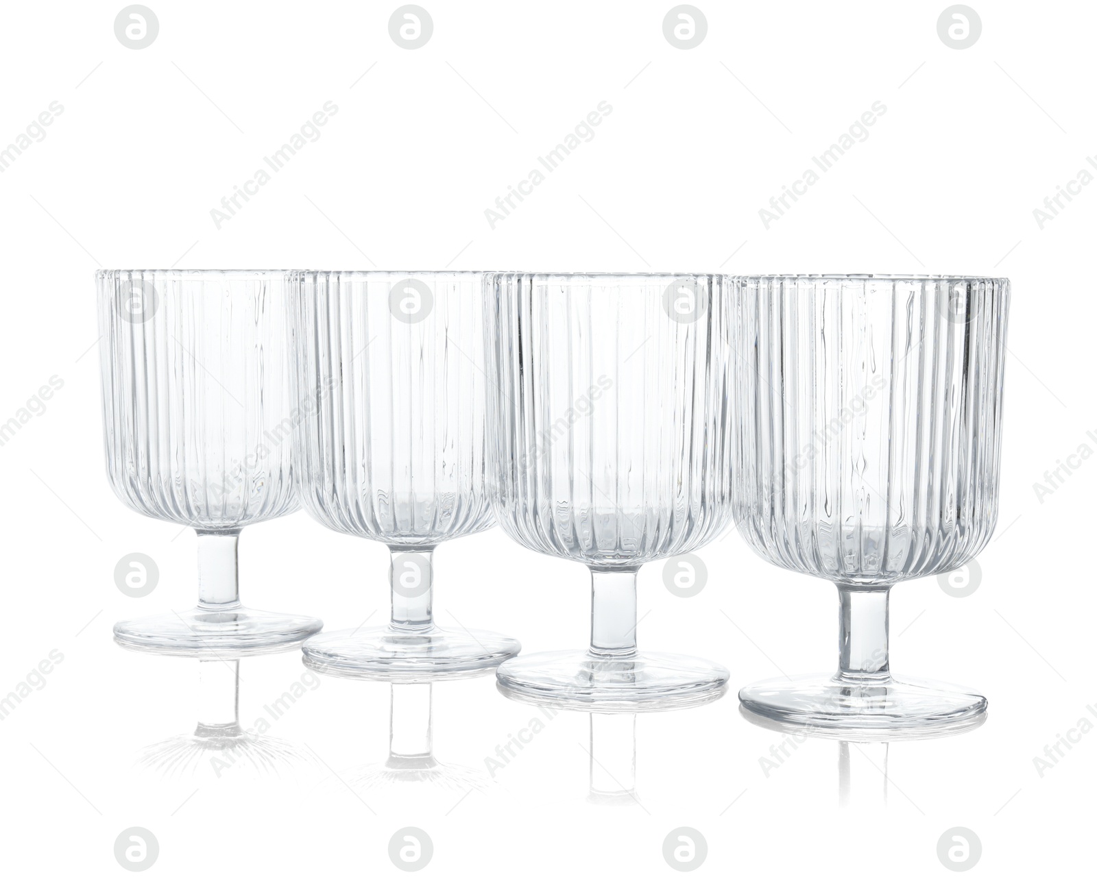 Photo of Many empty clean glasses isolated on white