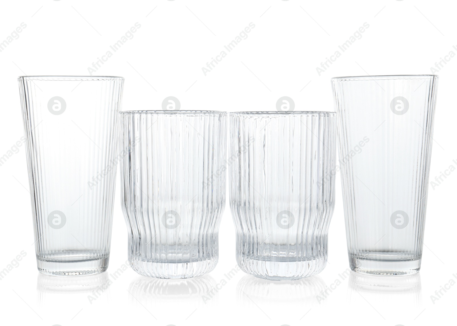 Photo of Many empty clean glasses isolated on white