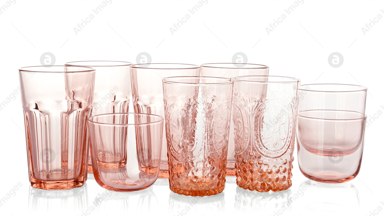 Photo of Many empty clean glasses isolated on white