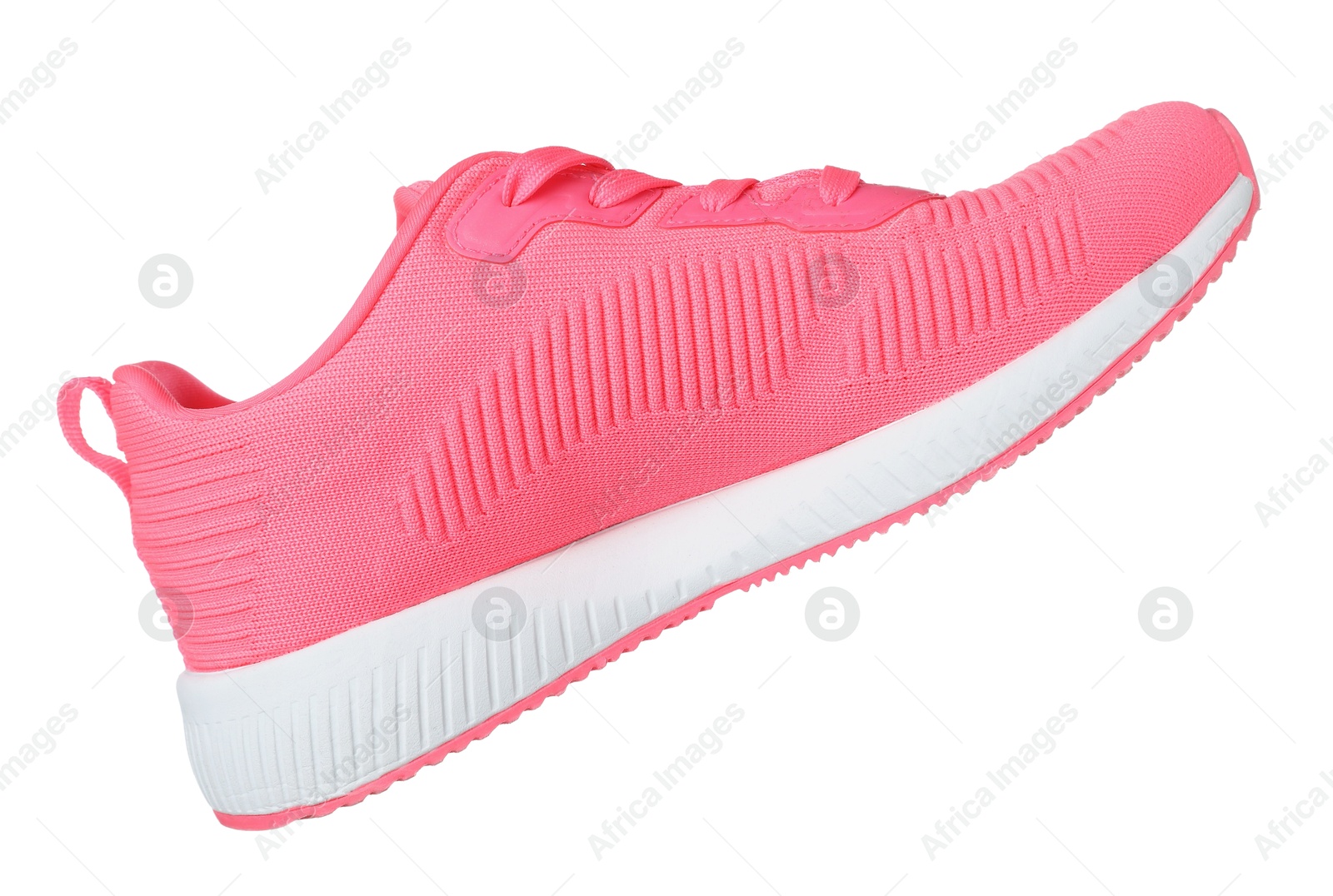 Photo of One pink sneaker in air isolated on white