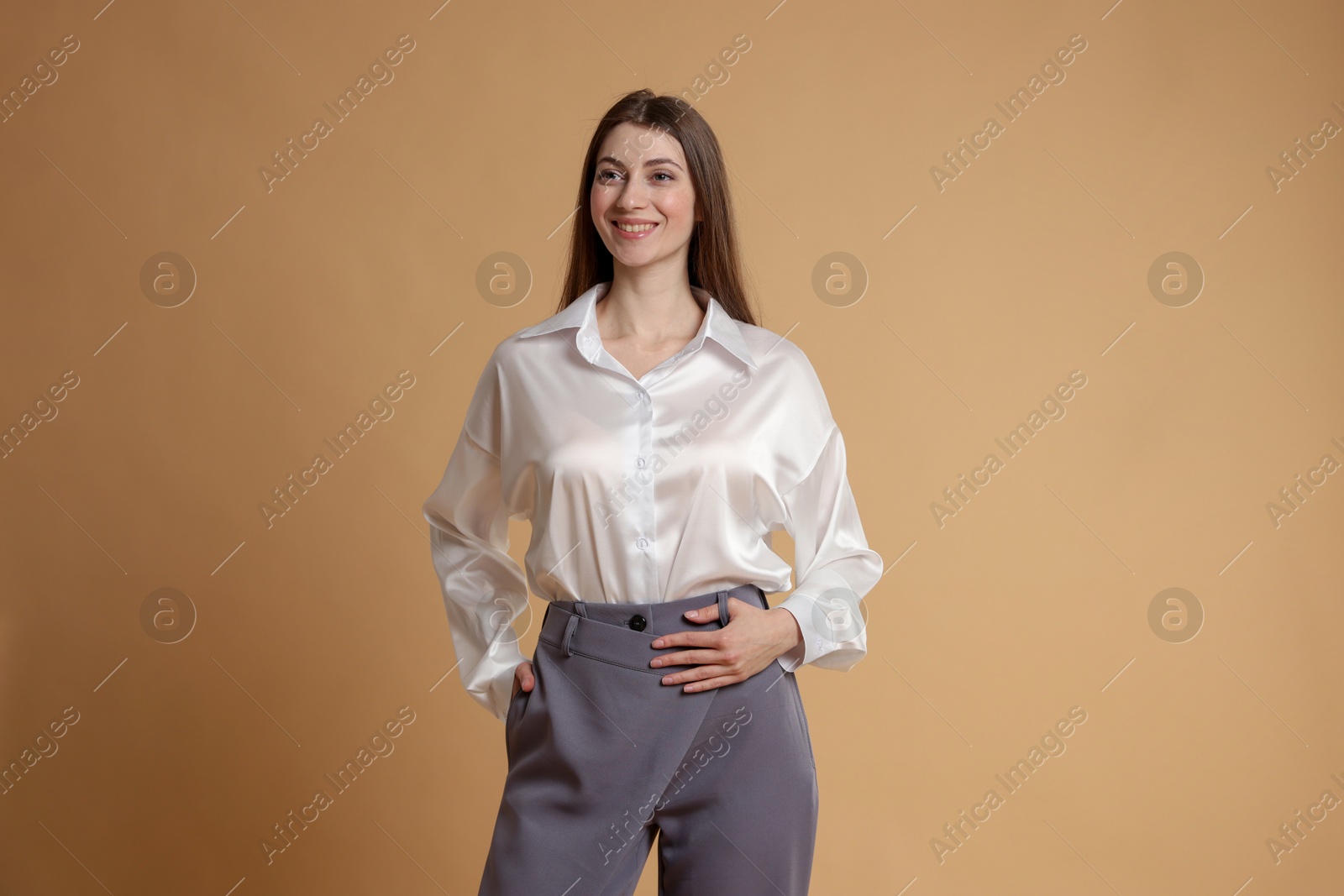 Photo of Beautiful woman in stylish outfit on beige background