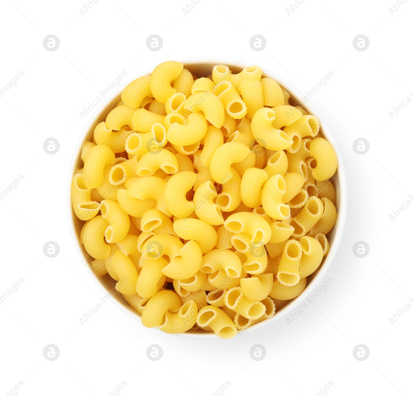 Photo of Raw horns pasta in bowl isolated on white, top view