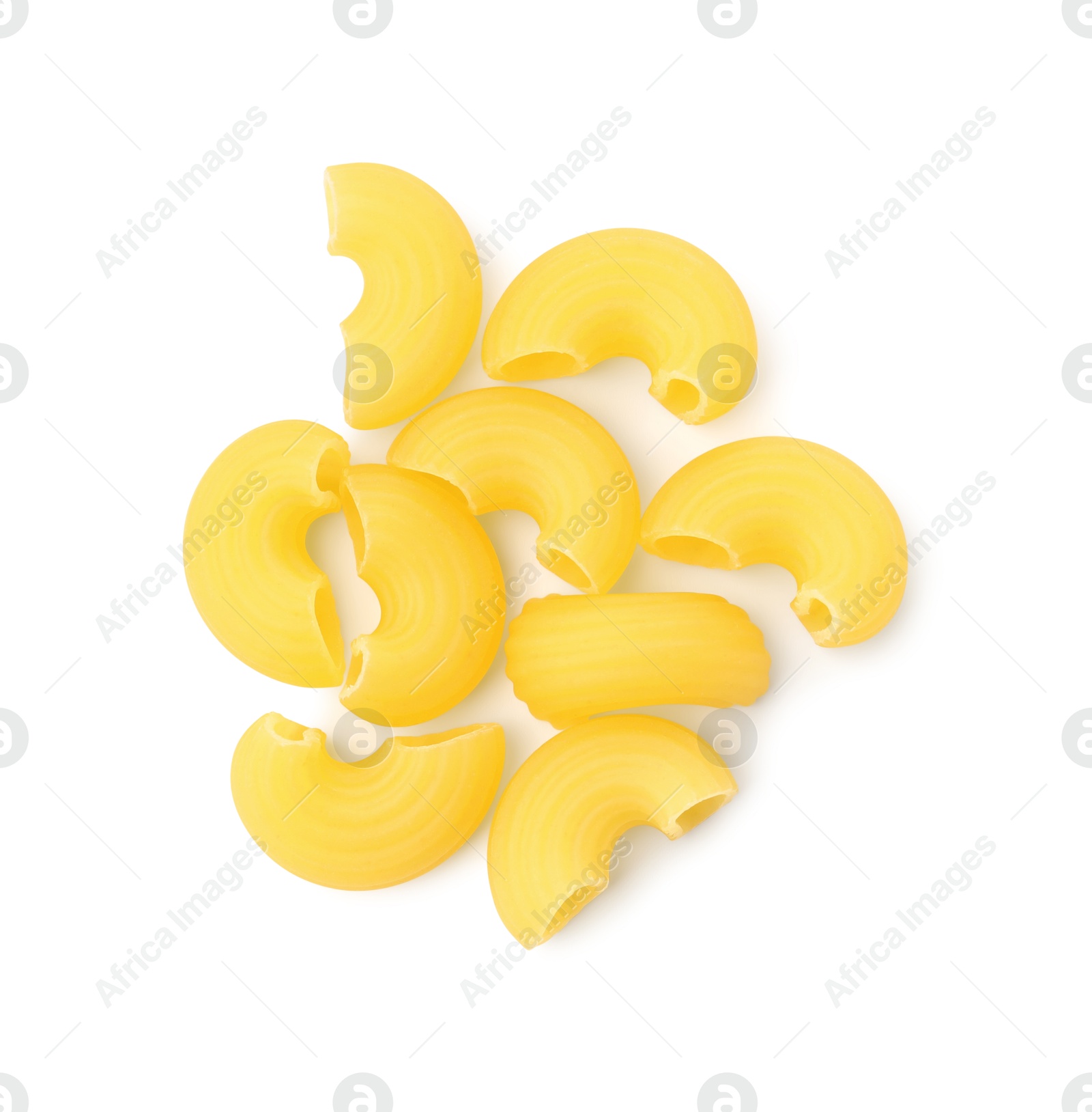 Photo of Pile of raw horns pasta isolated on white, top view