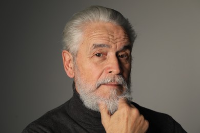 Photo of Portrait of bearded senior man on grey background