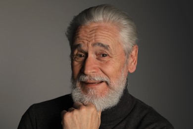 Photo of Portrait of bearded senior man on grey background