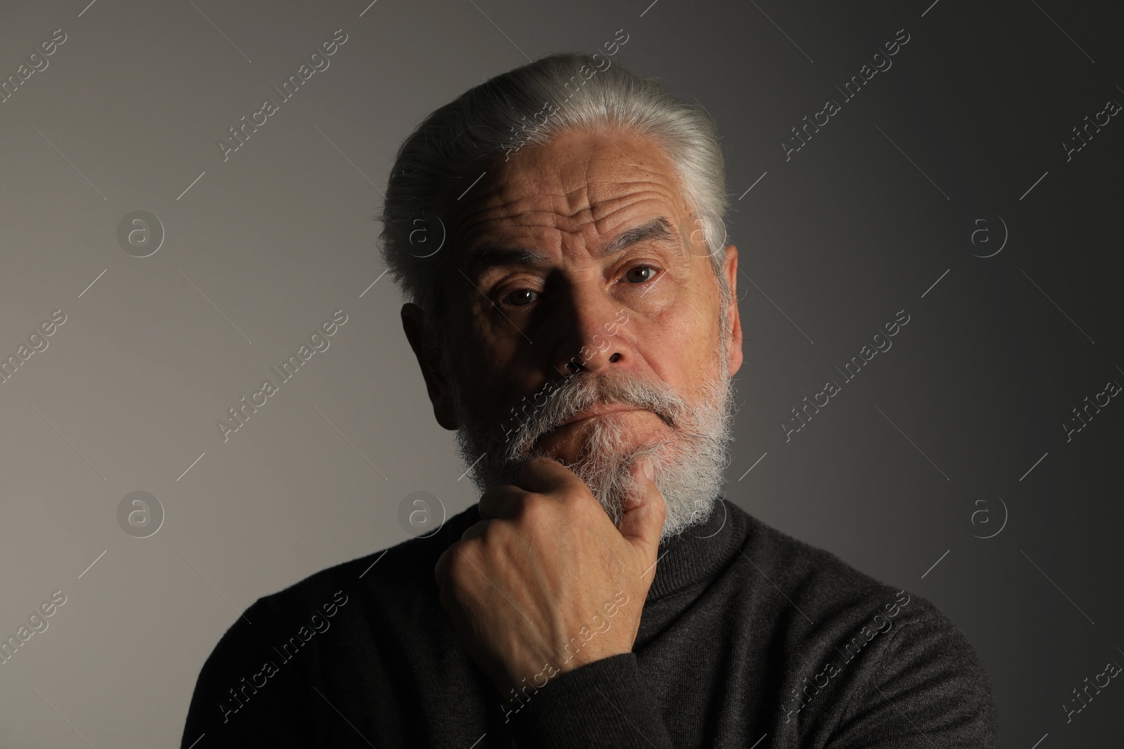 Photo of Portrait of bearded senior man on grey background