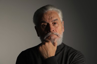 Photo of Portrait of bearded senior man on grey background