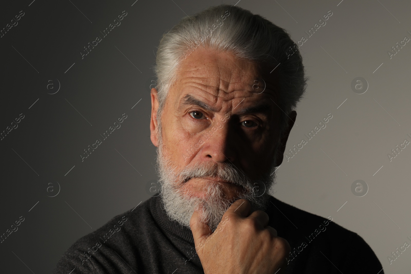 Photo of Portrait of bearded senior man on grey background