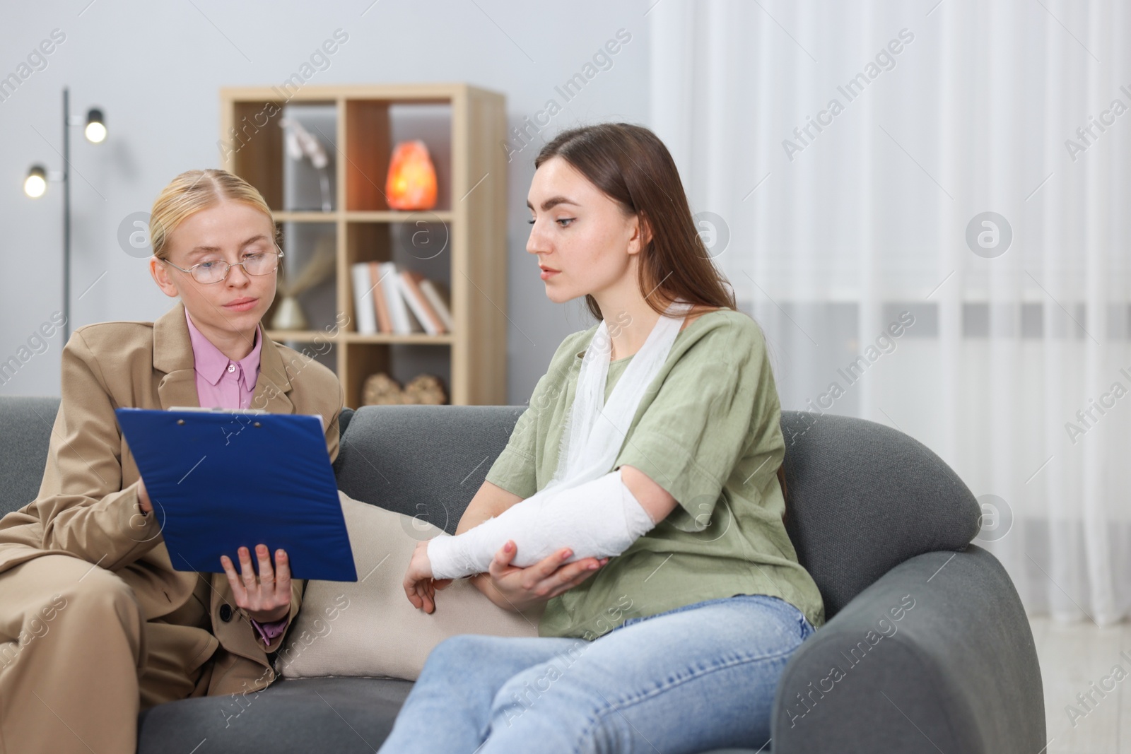 Photo of Injured woman having meeting with lawyer in office