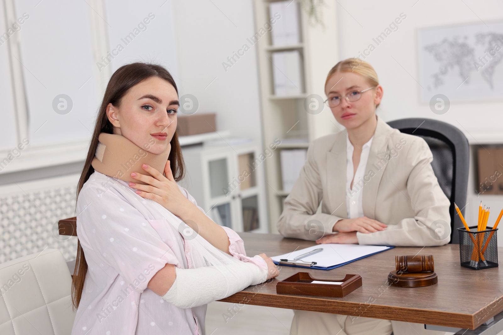 Photo of Injured woman and lawyer in office, selective focus