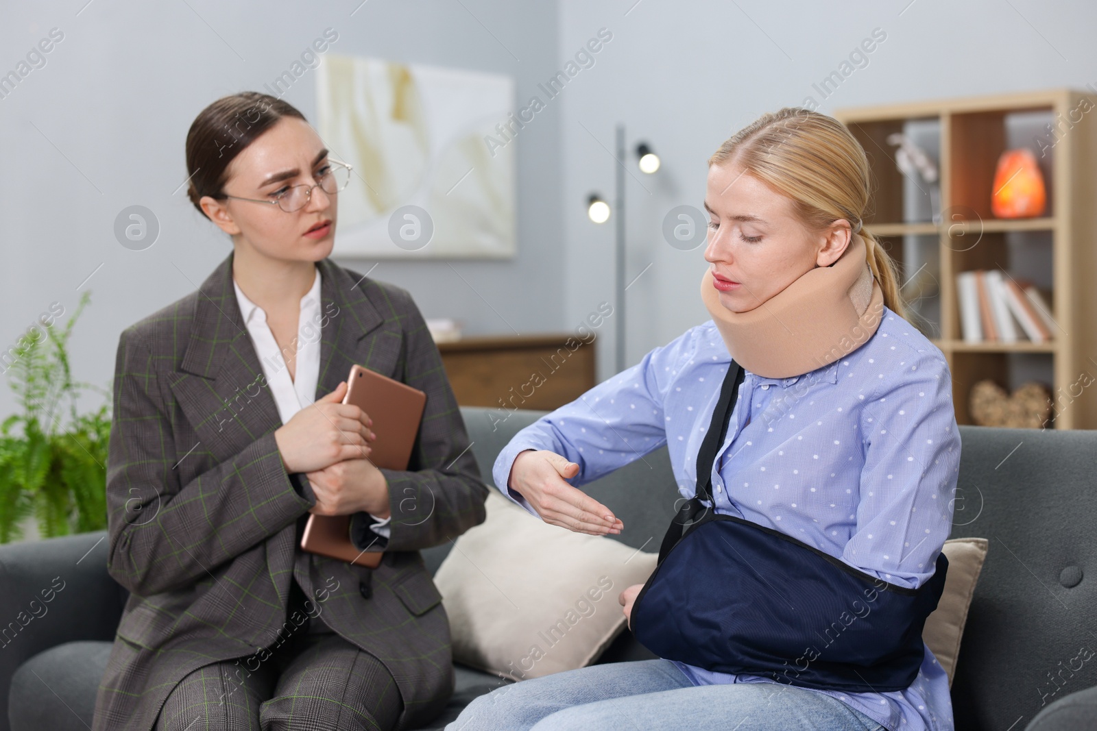 Photo of Injured woman having meeting with lawyer in office