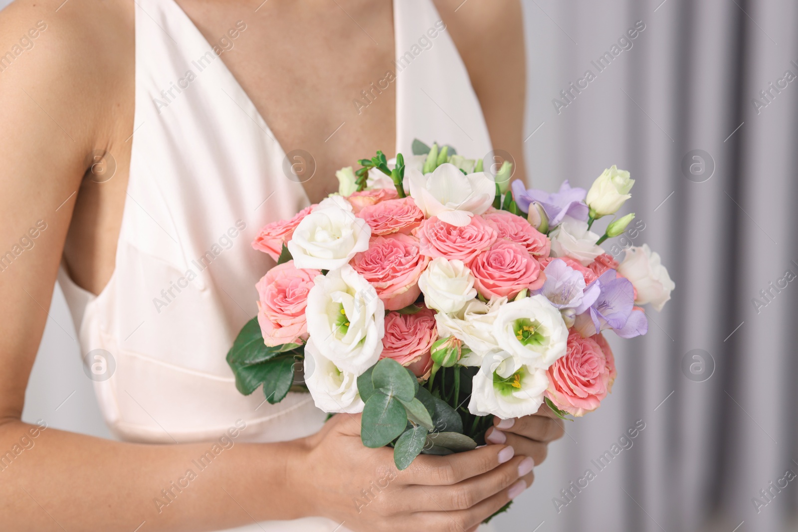 Photo of Bride with beautiful wedding bouquet on light background, closeup