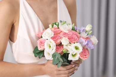 Photo of Bride with beautiful wedding bouquet on light background, closeup