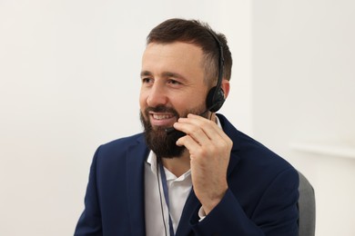 Photo of Technical support call center. Portrait of smiling operator in office