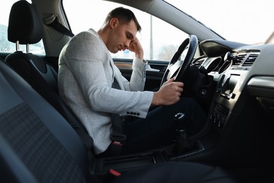 Photo of Tired driver sleeping in his modern car