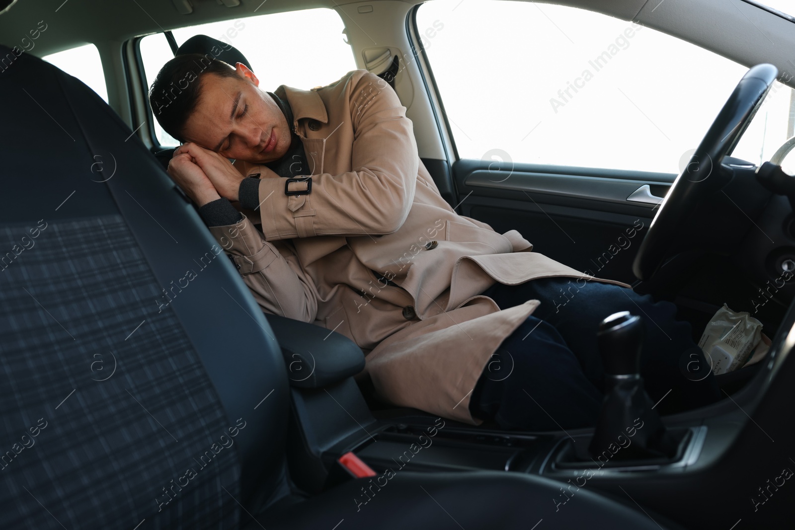 Photo of Tired driver sleeping in his modern car