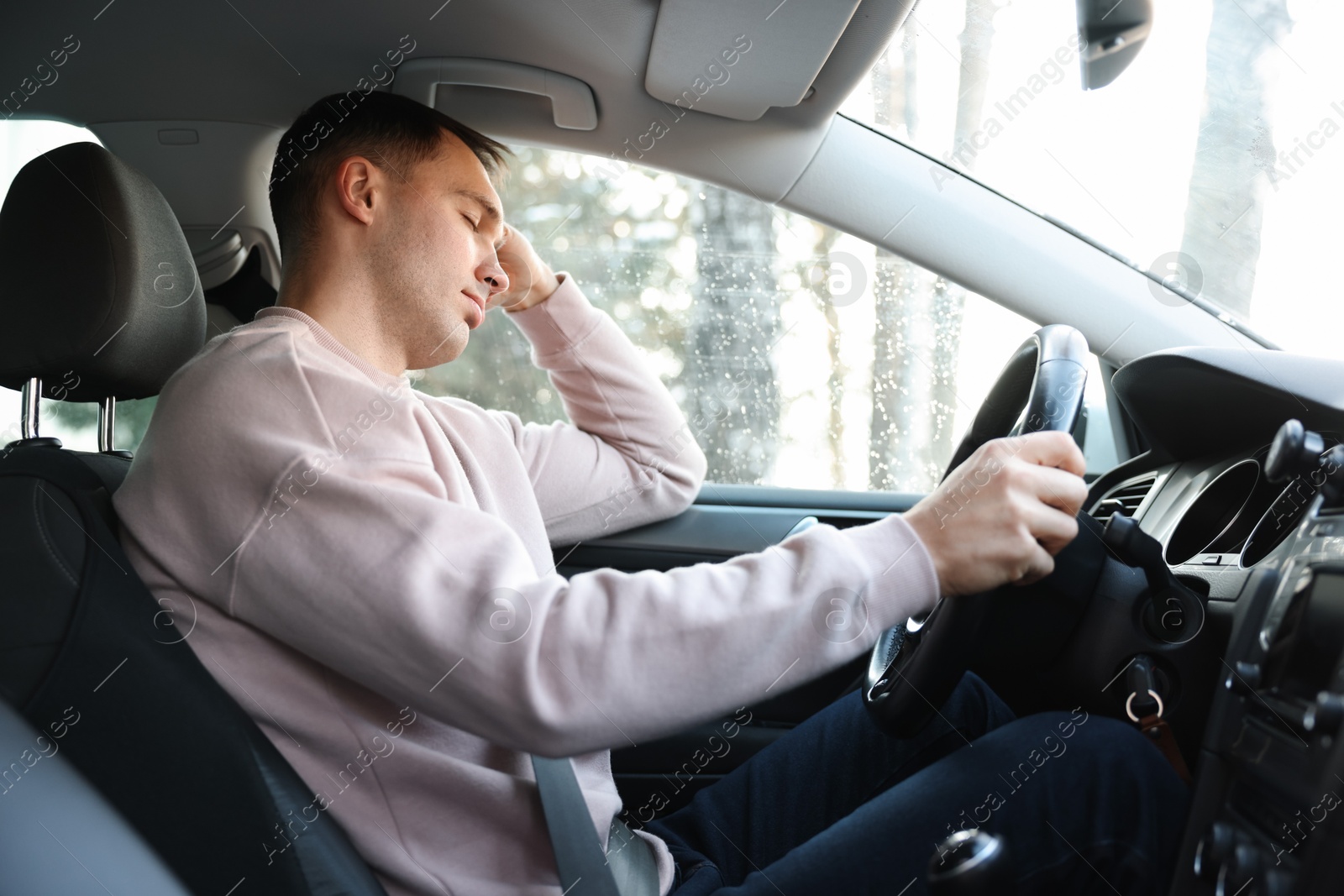 Photo of Tired driver sleeping in his modern car