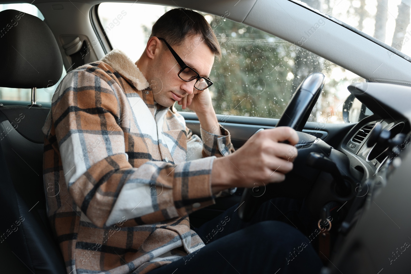 Photo of Tired driver sleeping in his modern car