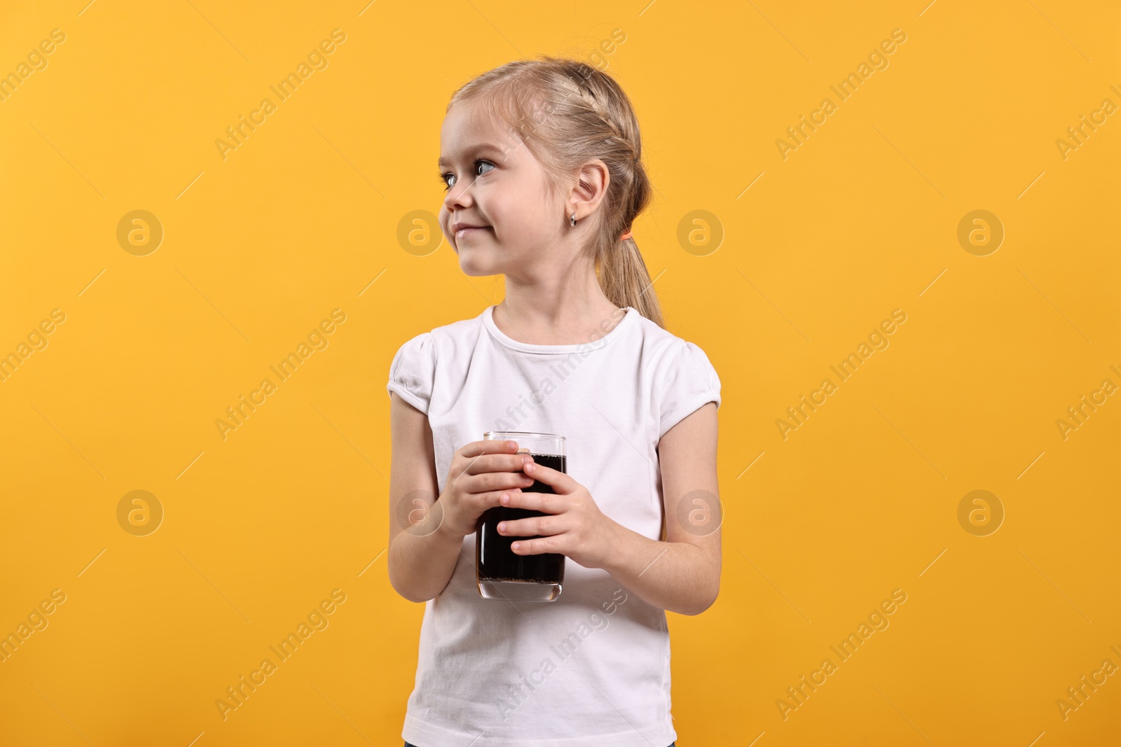 Photo of Girl with glass of refreshing soda drink on orange background