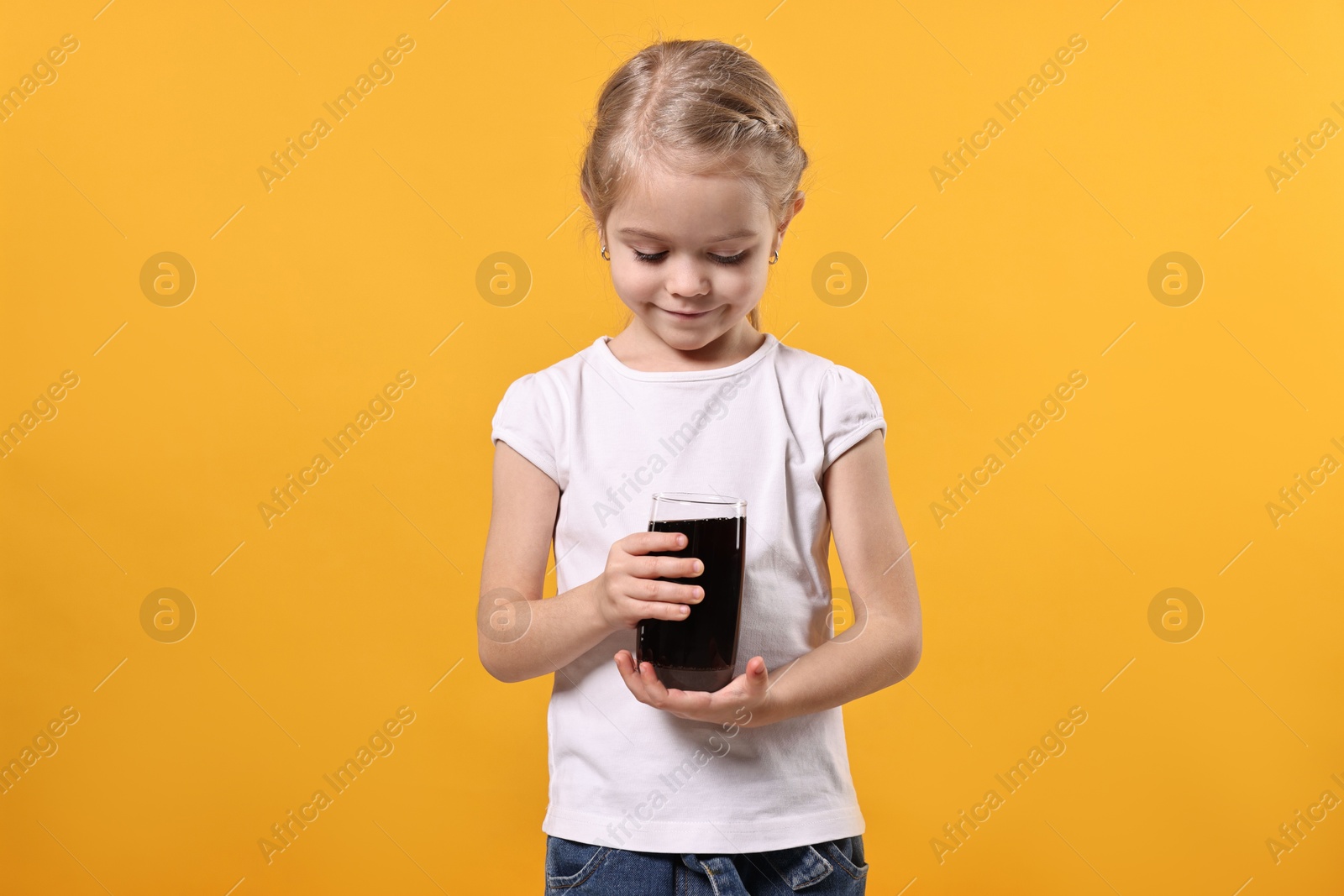 Photo of Girl with glass of refreshing soda drink on orange background