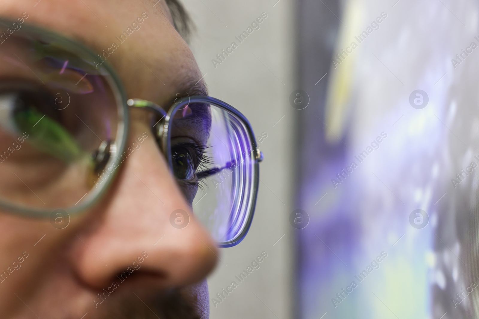 Photo of Man wearing stylish glasses on blurred background, closeup