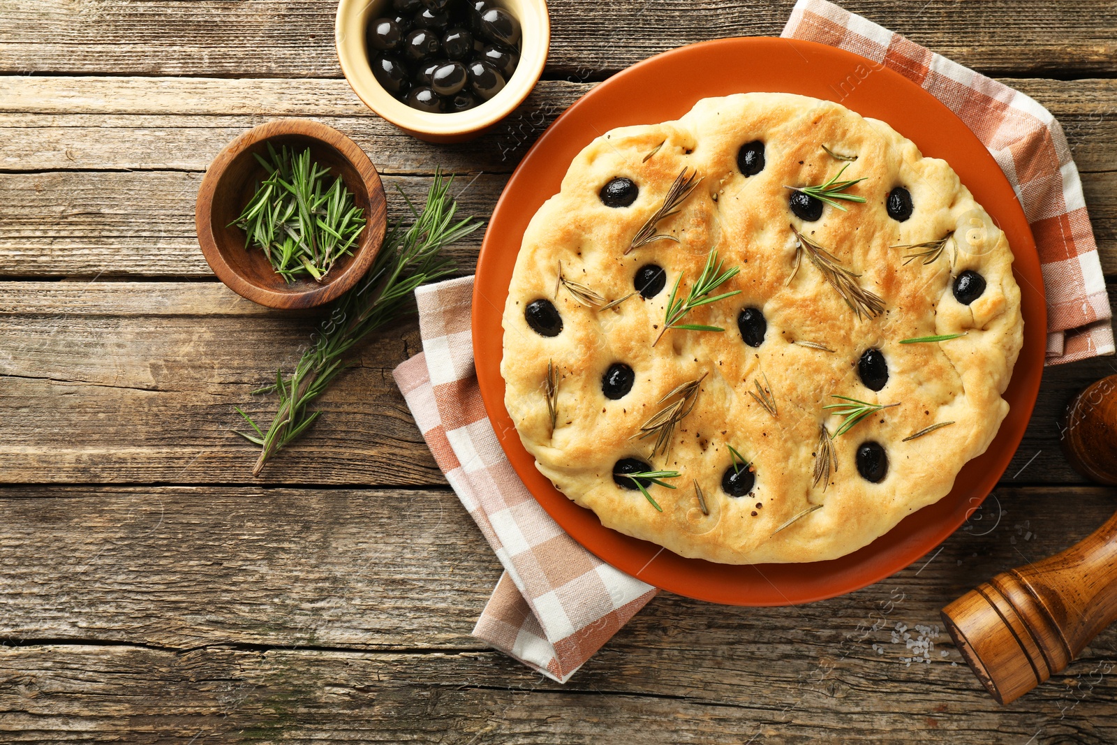 Delicious focaccia bread with olives, rosemary and spices on wooden table, flat lay. Space for text Photo of Delicious focaccia bread with olives, rosemary and spices on wooden table, flat lay. Space for text