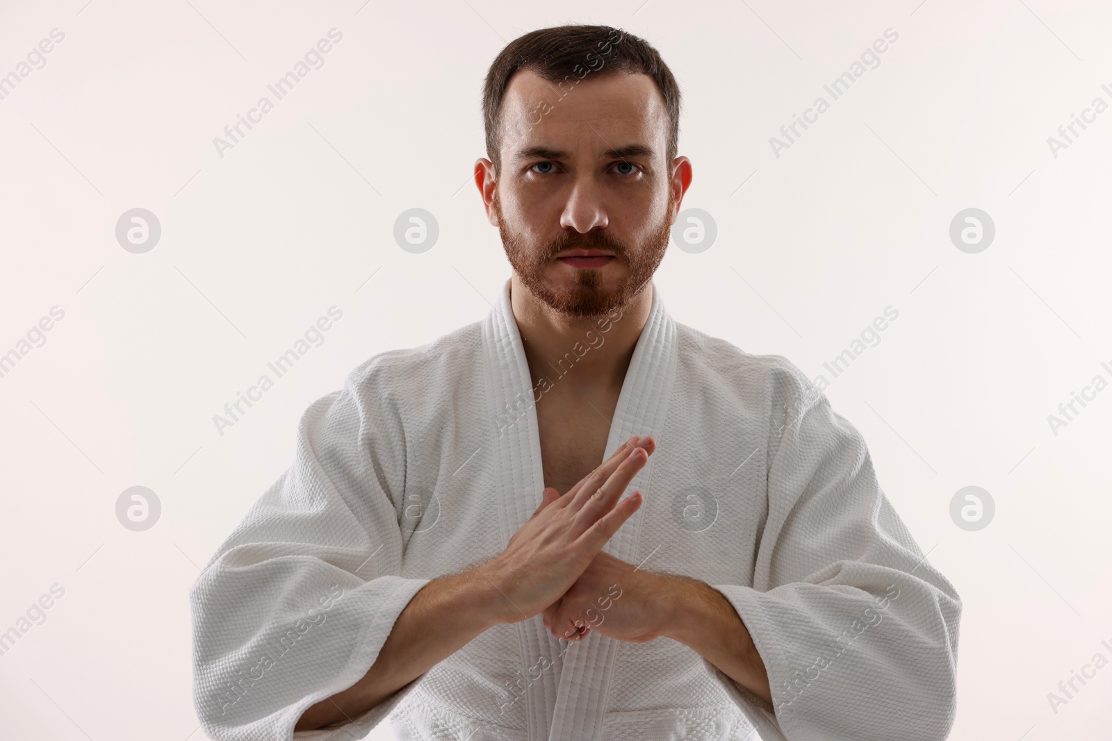 Photo of Karate fighter in uniform on white background