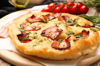 Photo of Delicious focaccia bread with bacon and parsley on table, closeup