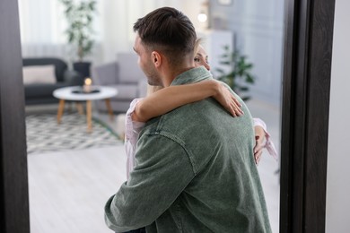 Photo of Happy woman welcoming friend to her apartment