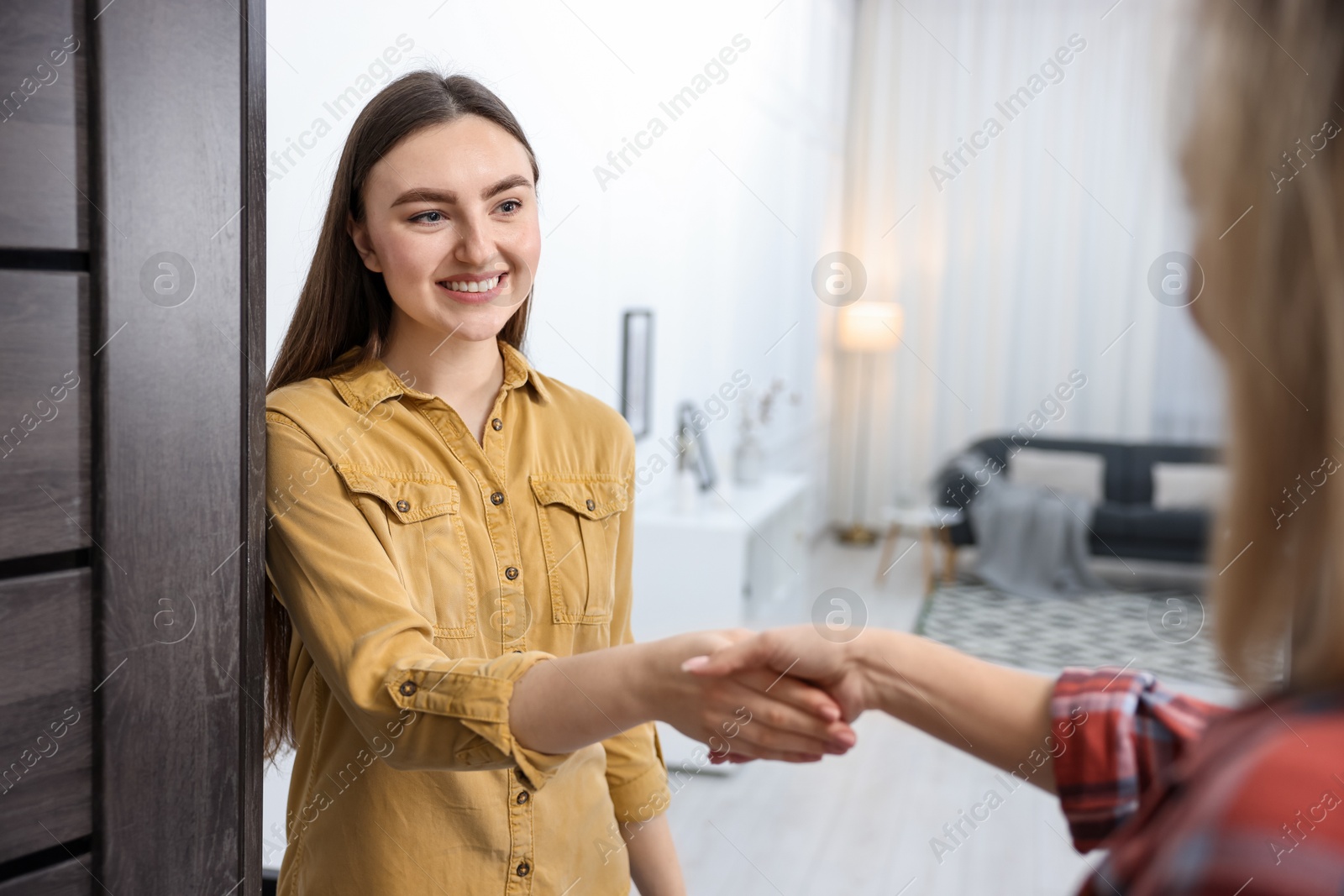 Photo of Happy woman meeting neighbor in her new apartment