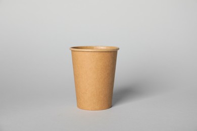Photo of Paper cup on grey background. Mockup for design